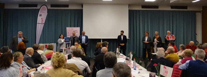 Ehrengäste zum Jahresempfang der KAB Bayern 2026 nehmen Aufstellung zum Achtstundentag.